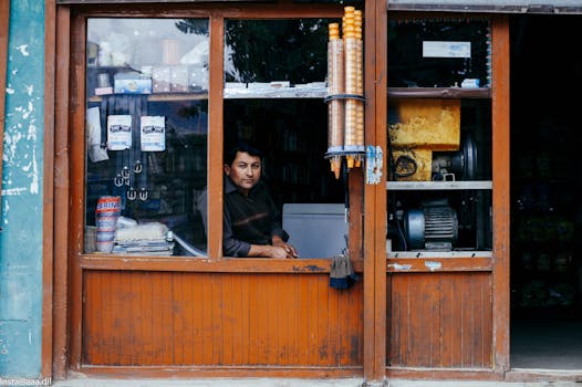 Ice cream vendor peeking out of a wooden store window in Garelt.