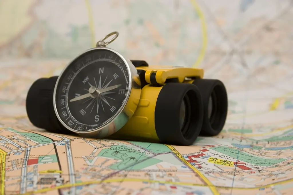Compass direction, Paper map and a pair of binoculars